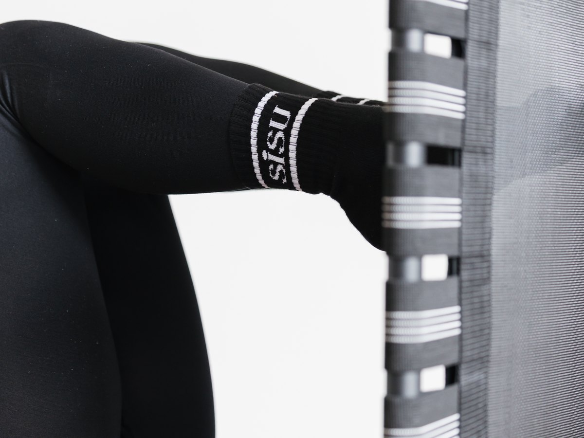A foot pressing into the jumpboard at the end of a reformer