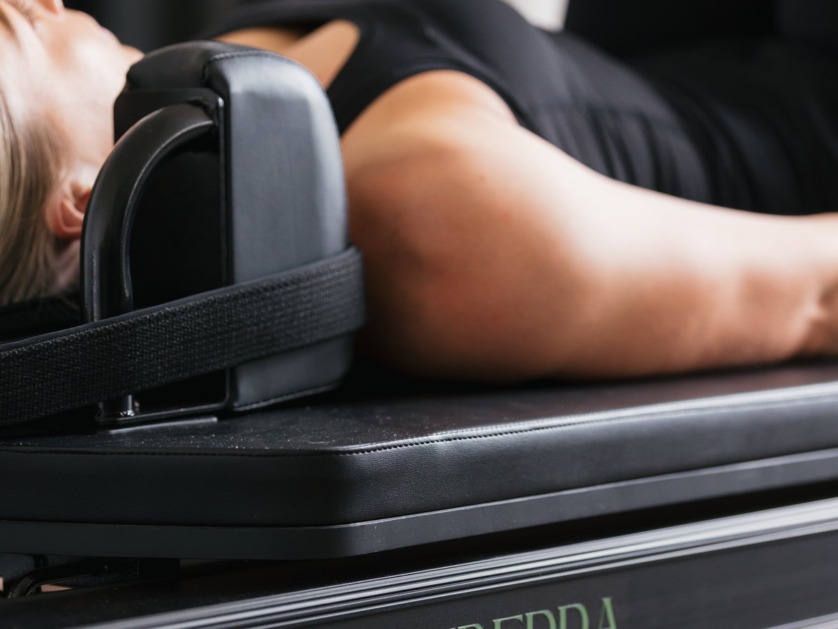 Lying back on a reformer in the SiSU Canberra studio